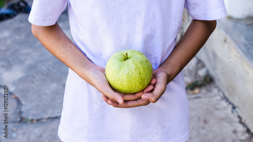 big guava in my hands of child(selective focus) © supitstockphoto