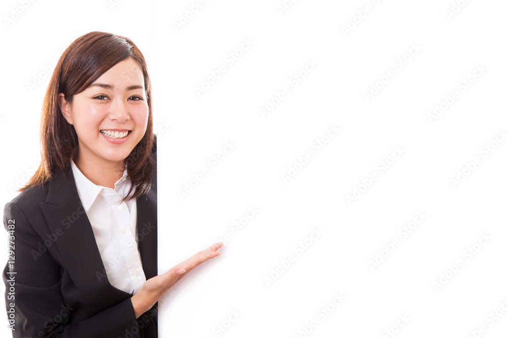 Smiling young business woman showing blank board while Smiling young business woman showing blank board while