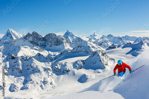 Skiing with amazing view of swiss famous mountains in beautiful photo