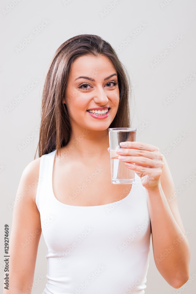 Portrait of young woman who is holding glass of water. Refreshment is important. Portrait of young woman who is holding glass of water. Refreshment is important.