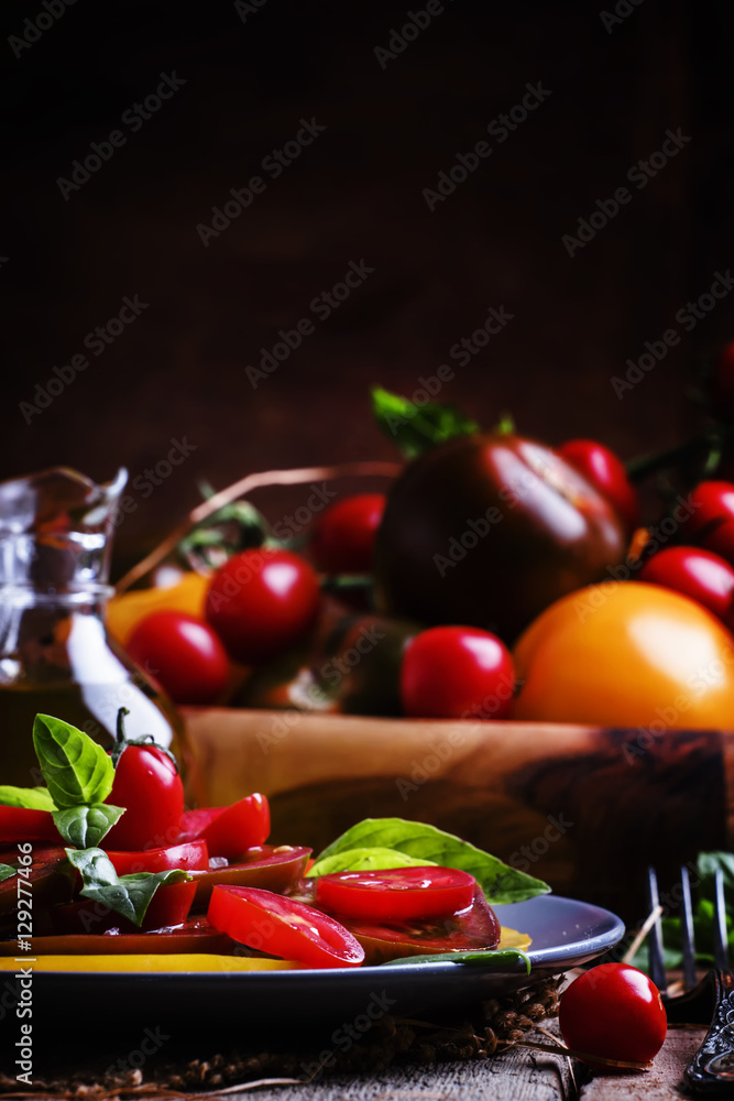 Salad with tomato and basil, old wooden background, selective fo Salad with tomato and basil, old wooden background, selective fo