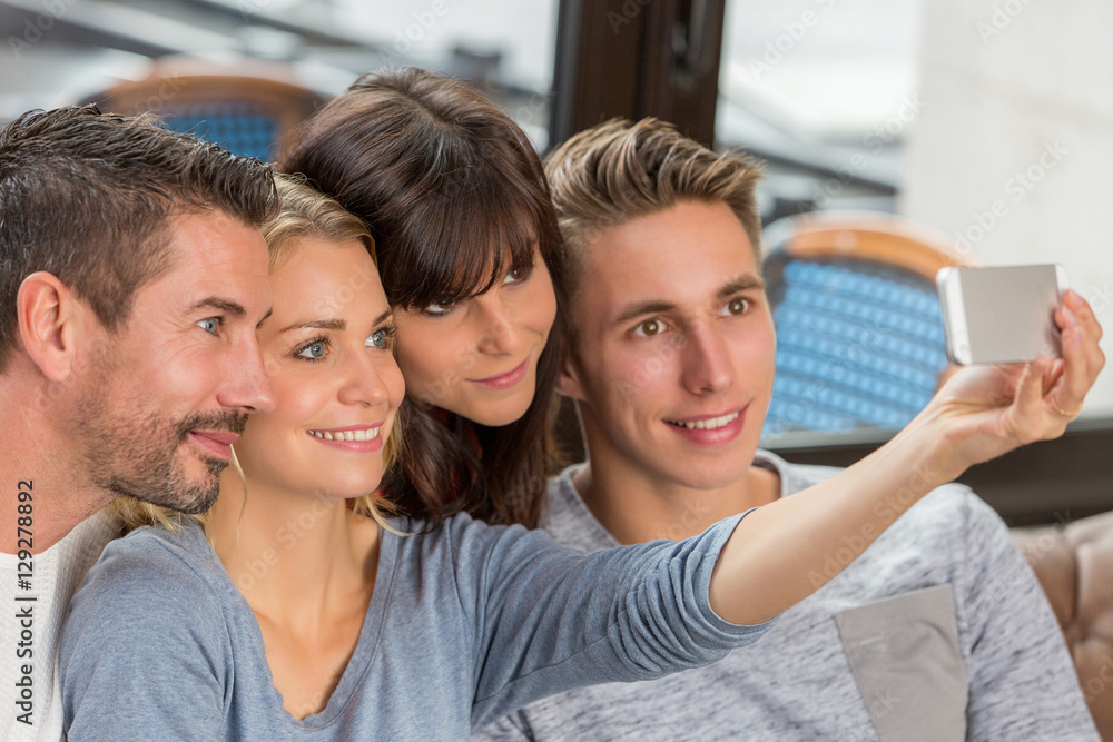 Obraz premium Group Of Young Adult Friends Taking Selfie