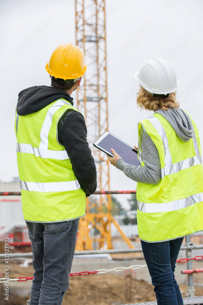 Construction manager and engineer working on building site Construction manager and engineer working on building site