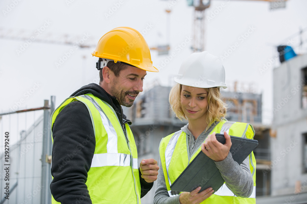 Construction manager and engineer working on building site Construction manager and engineer working on building site