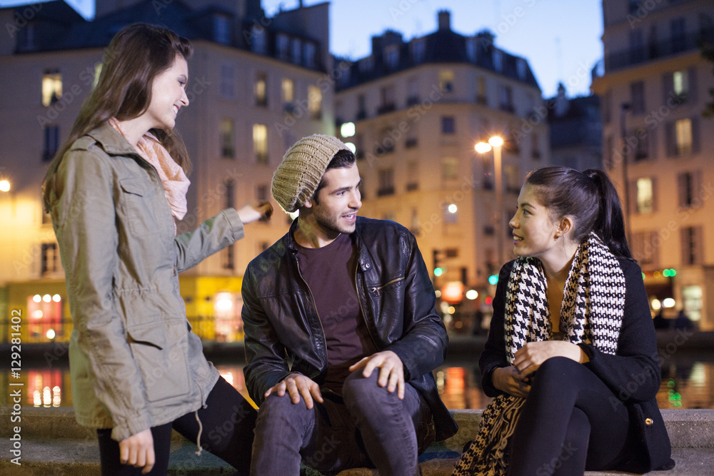 Friends hanging out together outdoors at night Friends hanging out together outdoors at night