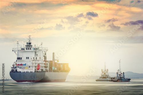 Logistics and transportation of International Container Cargo ship with tugboat in the ocean at sunset time, Freight Transportation, Shipping
