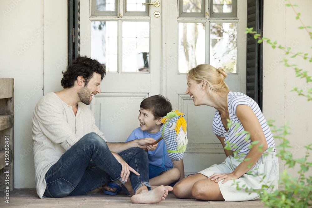 Family with one child having lighthearted time together outdoors Family with one child having lighthearted time together outdoors