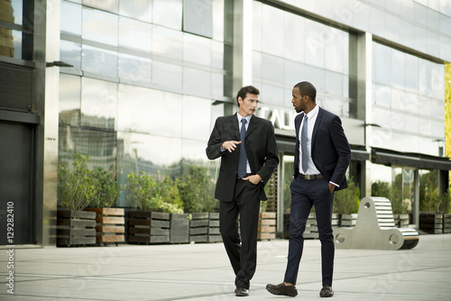 Business colleagues walking and talking together
