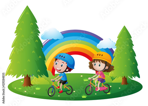 Boy and girl riding bicycle in park