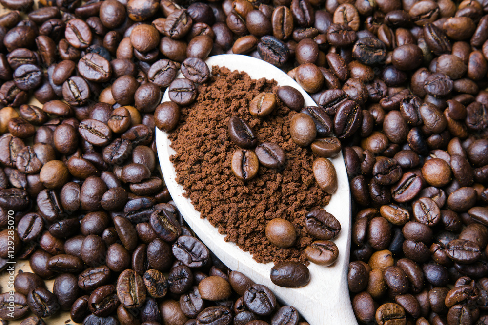 instant coffee in spoon on coffee beans background instant coffee in spoon on coffee beans background