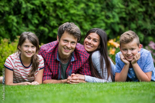 Portrait of happy family lying in park