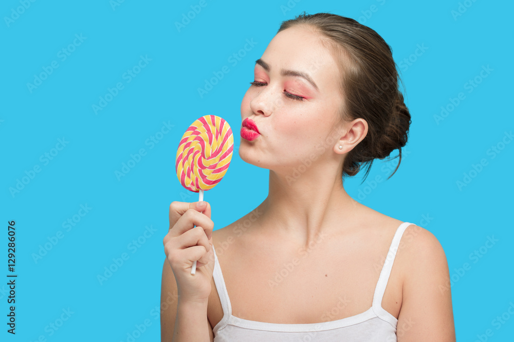 fun girl with candy on blue background