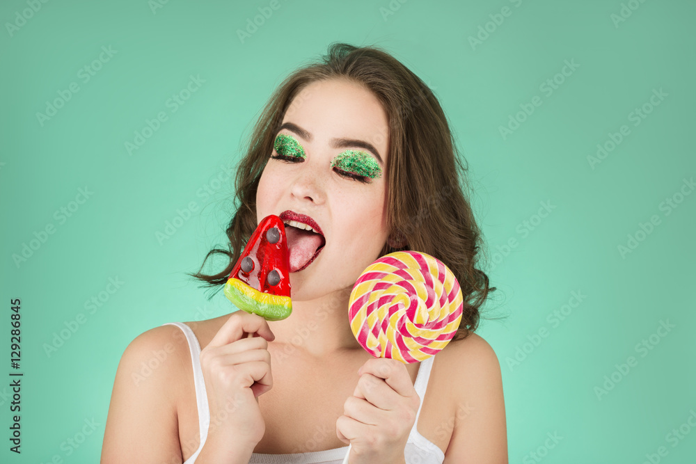 fun girl licks candy on green background fun girl licks candy on green background