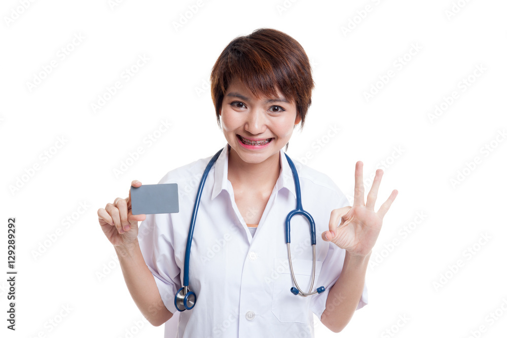 Asian young female doctor show Ok sign with blank card. Asian young female doctor show Ok sign with blank card.