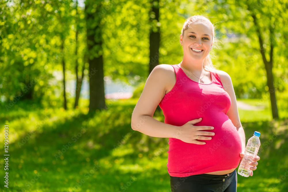 potbellied pregnant woman happy portrait in the park potbellied pregnant woman happy portrait in the park
