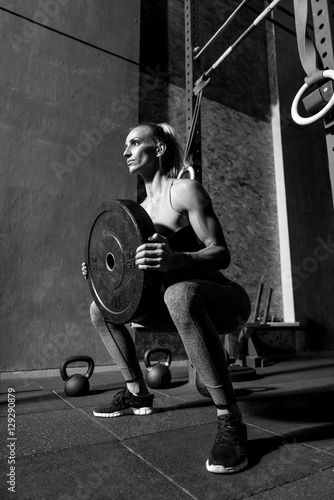 Good looking sporty woman holding dumbbell weight