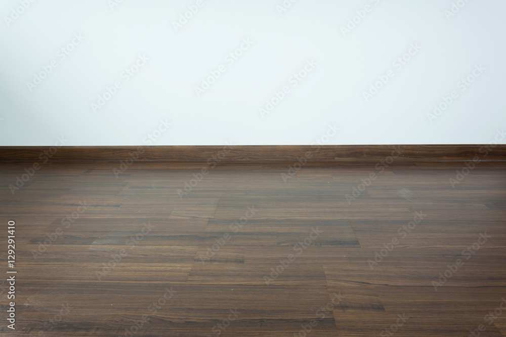 empty room interior, brown wood laminate floor and white mortar empty room interior, brown wood laminate floor and white mortar