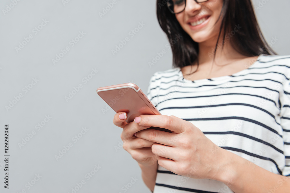 Fototapeta premium Cropped picture of happy young woman chatting by phone
