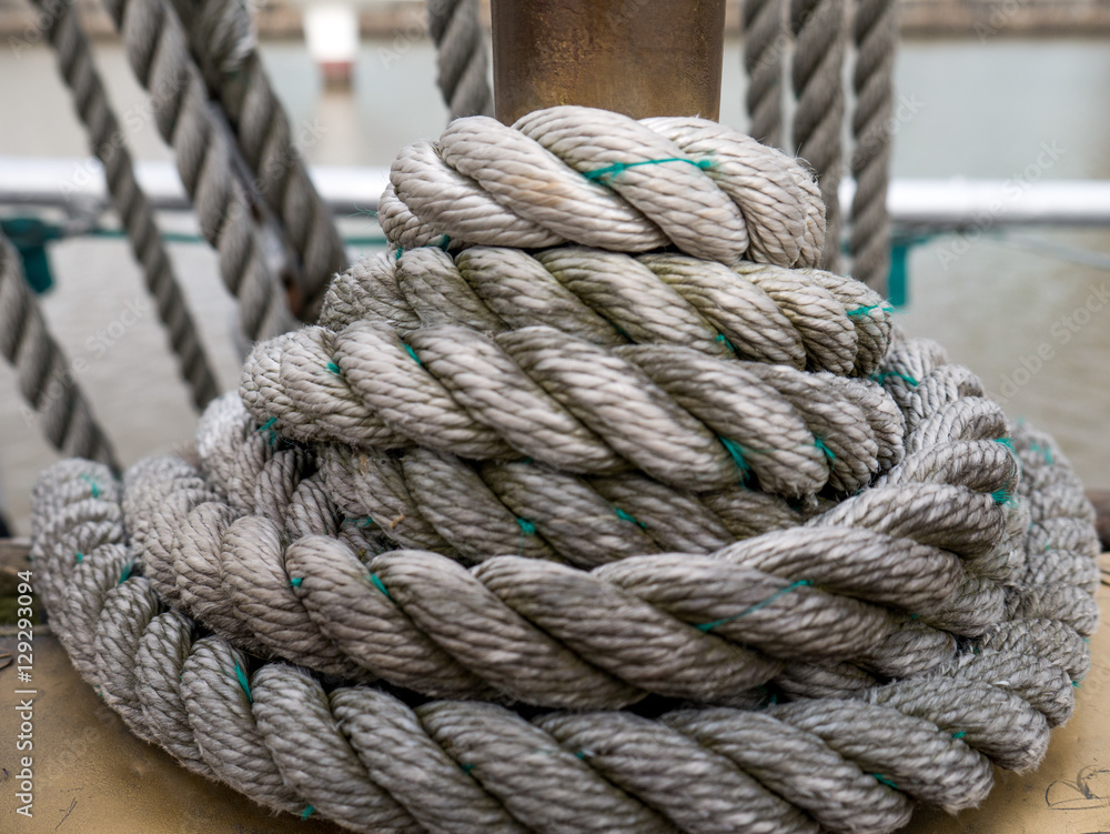 Tight rope knot on wood of ship.