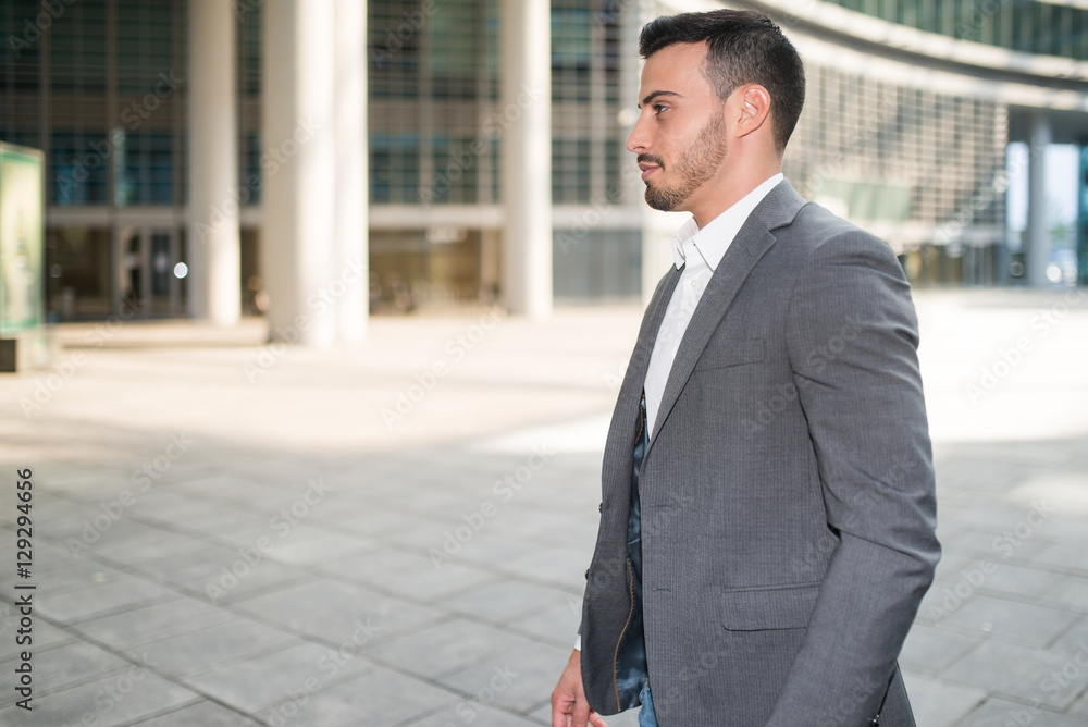 Businessman walking in a modern business environment Businessman walking in a modern business environment