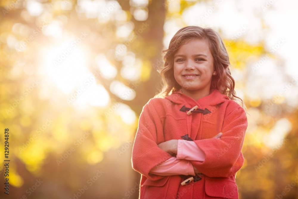 Cute girl with arms crossed against autumn tree Cute girl with arms crossed against autumn tree