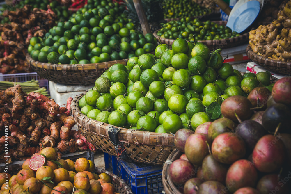 Green limes in basket on fruit market. Green limes in basket on fruit market.