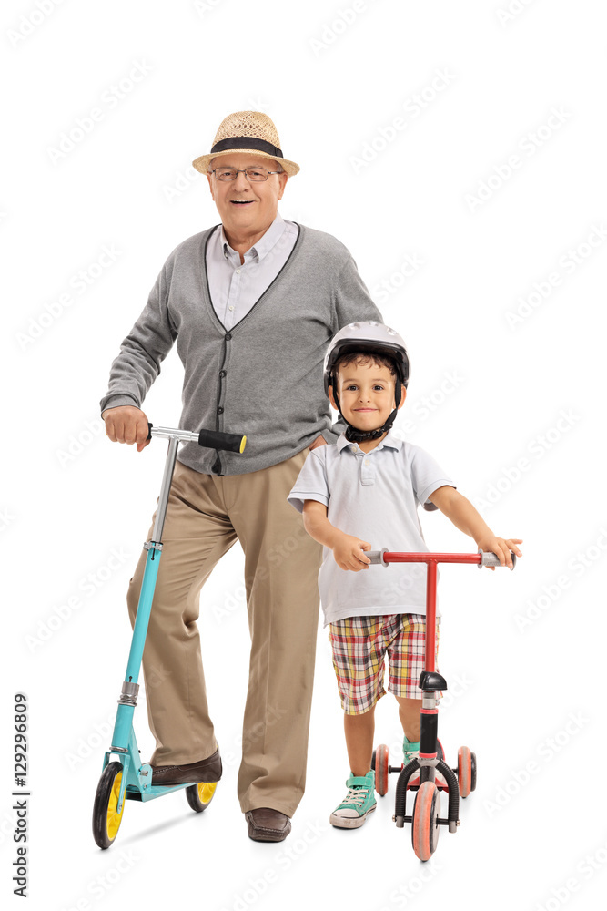 Elderly man and a little boy with scooters Elderly man and a little boy with scooters