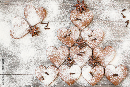 Christmas heart shaped cookies with sugar powder. Stylized like a fir tree. Top view.