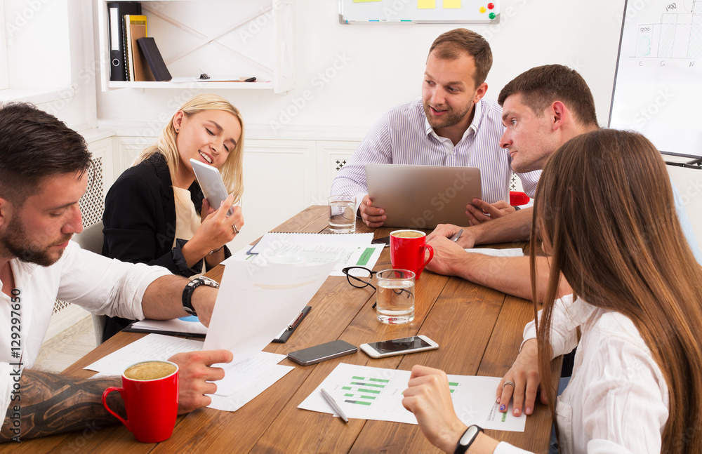 Business meeting. Young hipsters businessmen and women at modern office