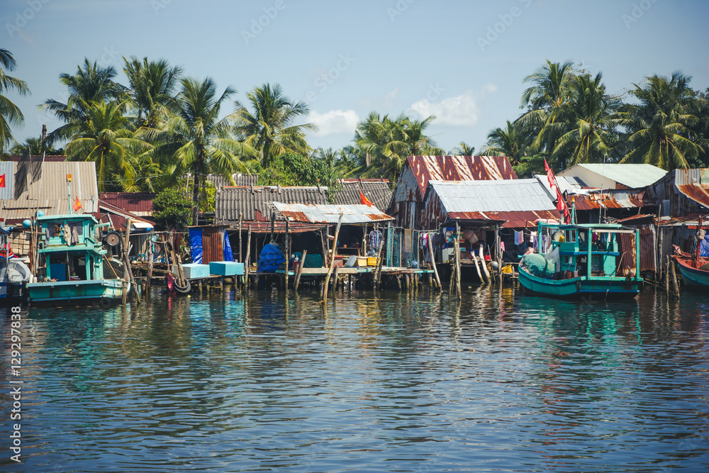 Fishing village with houses and boats in Vietnam.
