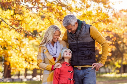 Smiling family at park during autumn