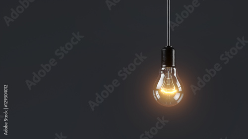 Electric lamp hanging on a wire in the room. Loneliness concept