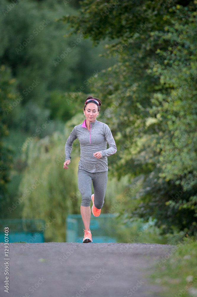 Running athlete woman. Female runner sprinting during outdoors t Running athlete woman. Female runner sprinting during outdoors t