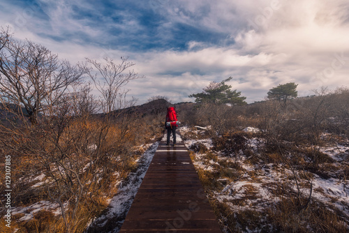 Guy with a travel enjoying and backpack in the Beautiful natural landscape in the winter time.