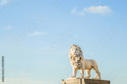 Sunny lion statue on the blue sky background. The South Bank Lion, also known as the Coade Stone Lion at the South bank, Westminster Bridge. photo