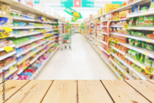 Wooden board empty table in front of blurred background. Perspective brown wood over store or supermarket concept sell product for mock up display or montage your products, vintage. 