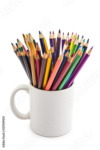 A stack of colored pencils of various color in a white cup on white background