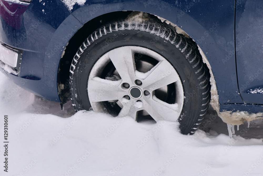 Car with winter tires on the snow covered road Car with winter tires on the snow covered road