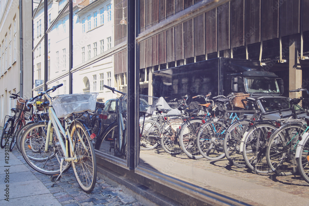 Bicycles on a street next to the shop window in Copenhagen, Denm