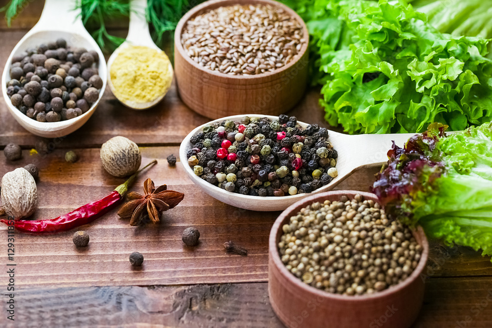 Beautiful colorful spices in wooden spoons on an old brown table. Beautiful colorful spices in wooden spoons on an old brown table.