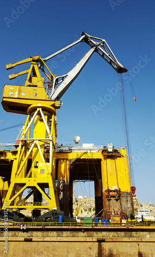 crane and oil platform in refitting at shipyard