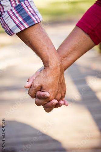 Close up of hiker couple holding hands