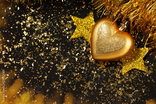 New year background, golden stars, christmas ball, glitter, black table