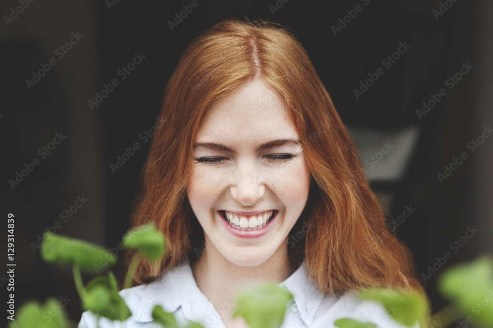 Close-up of smiling woman with eyes closed standing at window Close-up of smiling woman with eyes closed standing at window