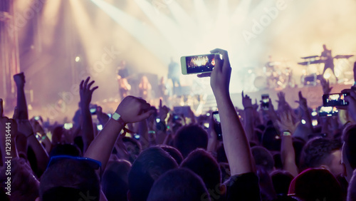 Fan taking photo of concert