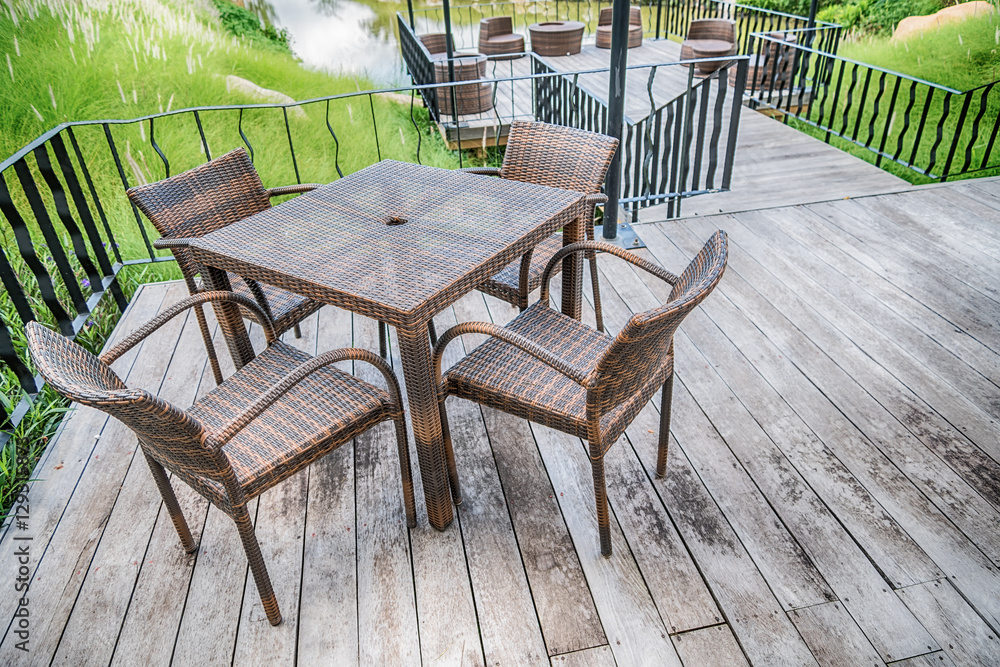 The wood table on natural outdoor of a restaurant with tree and
