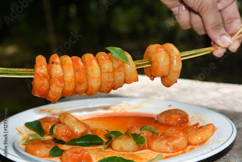 Spicy stir fried shrimp in thai red curry paste also popular seafood fish in Kerala India