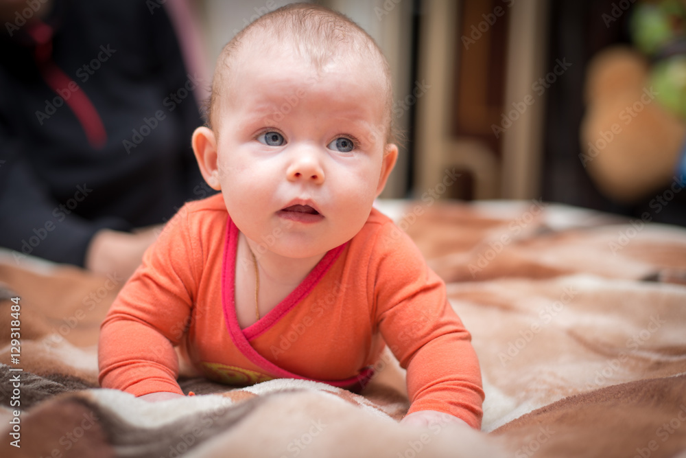 infant lying on the bed and looking infant lying on the bed and looking
