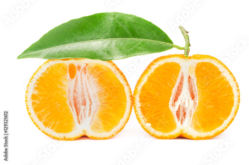 Mandarin with leaf cut in half isolated on a white