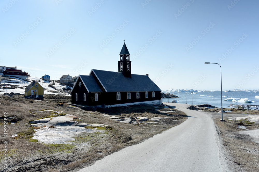 scenic view of the ilulissat city with iceberg on arctic ocean